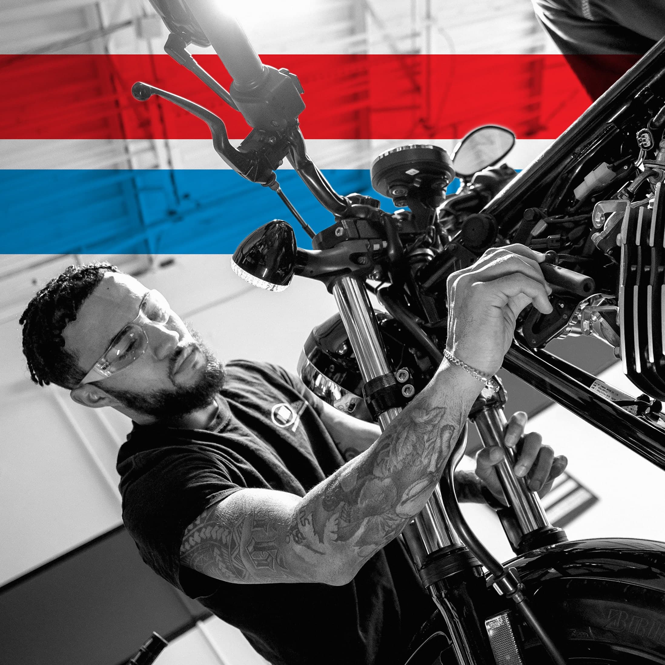 UTI trade school graduate wearing a black cap and gown with honor cords, smiling at commencement ceremony.