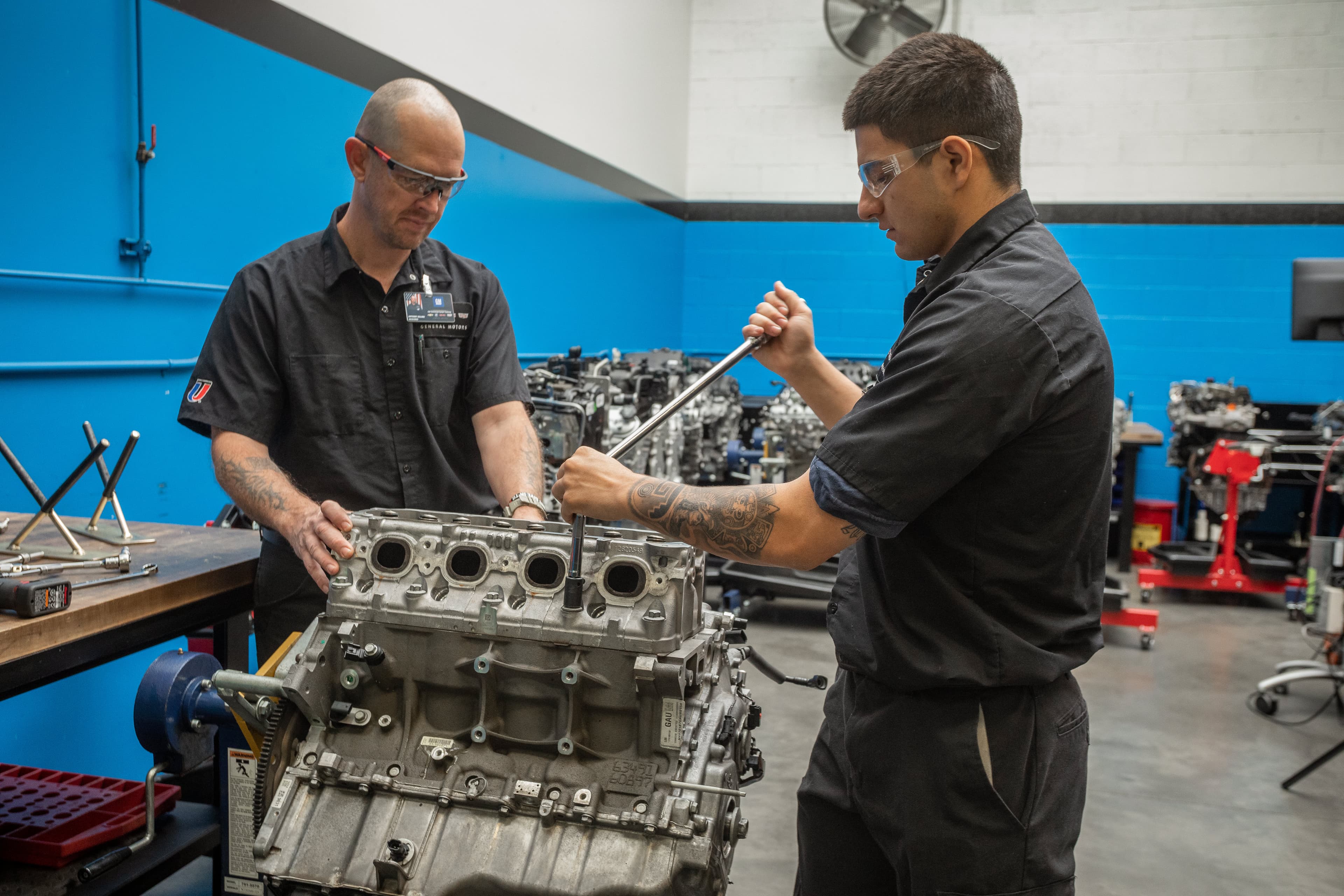UTI student inspects and tests a heavy-duty diesel engine on a white semi.