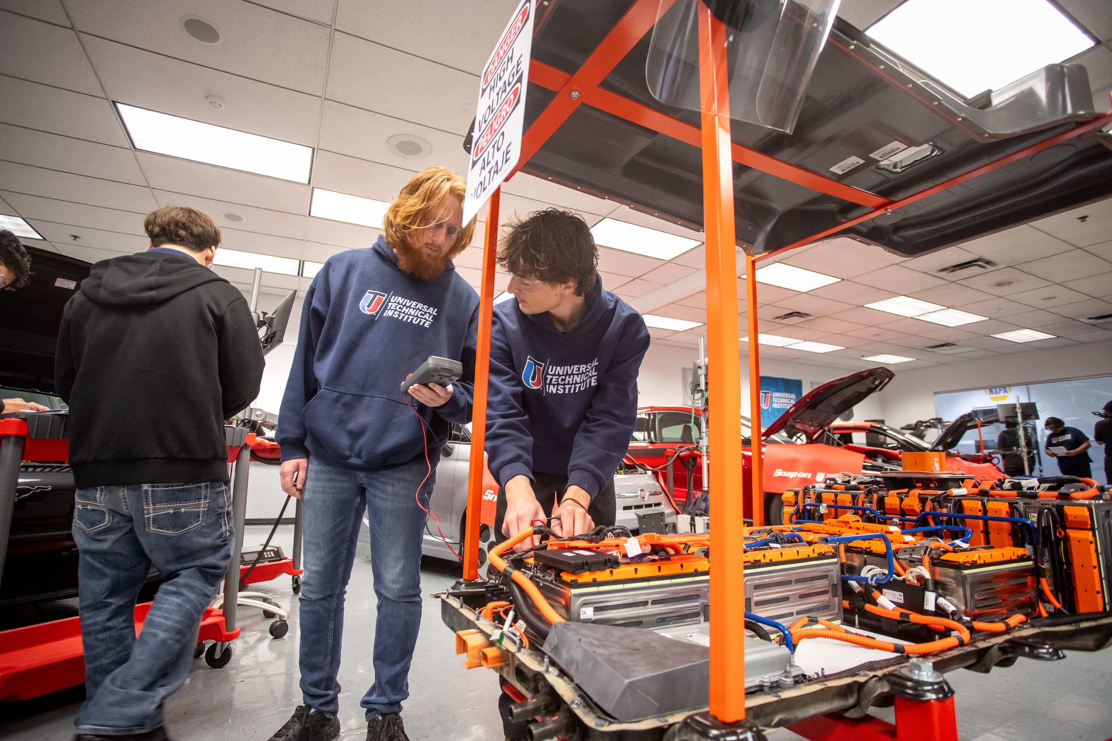 UTI student inspects and tests a heavy-duty diesel engine on a white semi.